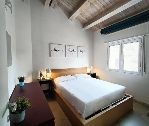 a bedroom with a large bed and a table at Terrazze Alba Sunshine in Marzamemi