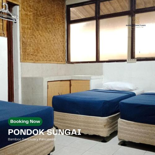two beds in a room with two windows at Bamboo Sanctuary Pancawati Resort Bogor in Ciherangsating