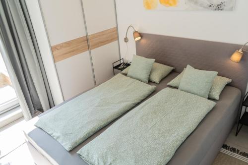 a bed with two pillows on it in a room at Perfect stay 2 in Maribor