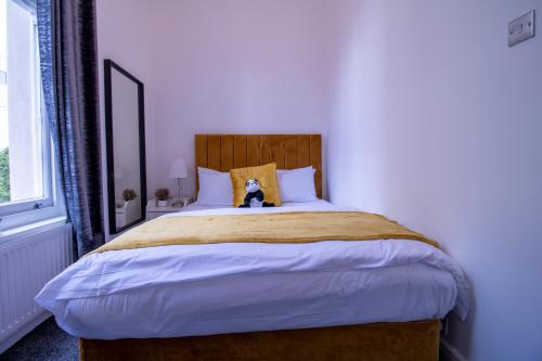 a bedroom with a bed with a dog sitting on it at Oxford Street Grandeur - Perfect for Large Groups in London