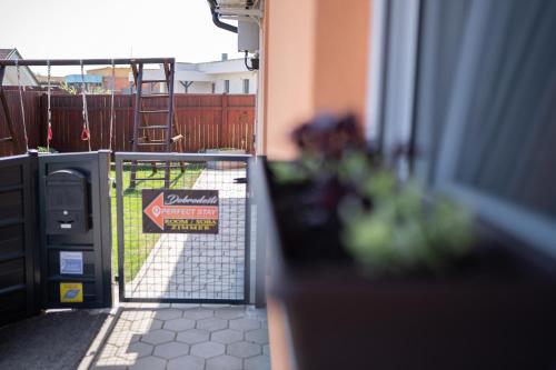 a gate with a sign in front of a yard at Perfect stay in Šentilj
