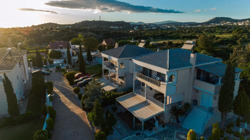 an overhead view of a house with a blue roof at Lagonisi Luxury Escape in Lagonissi