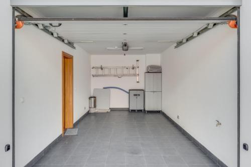 an empty garage with white walls and a tile floor at Casa Morena by Atlantic Holiday in Santa Cruz