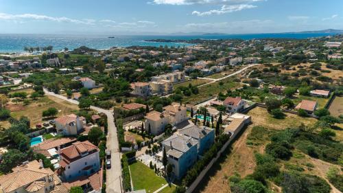 an aerial view of a city with houses and the ocean at Lagonisi Luxury Escape in Lagonissi