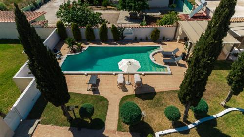 an overhead view of a swimming pool with trees at Lagonisi Luxury Escape in Lagonissi