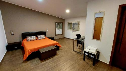 a bedroom with a bed and a desk in it at Il Mirto E La Rosa in Arenella