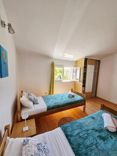 a bedroom with two beds and a window at Apartment Loli - Nin in Nin