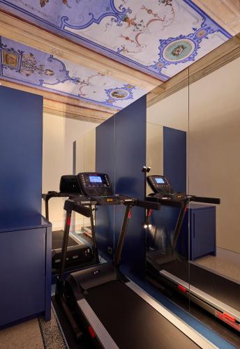 a gym with two treadmills and a ceiling at Gironda in Ravenna