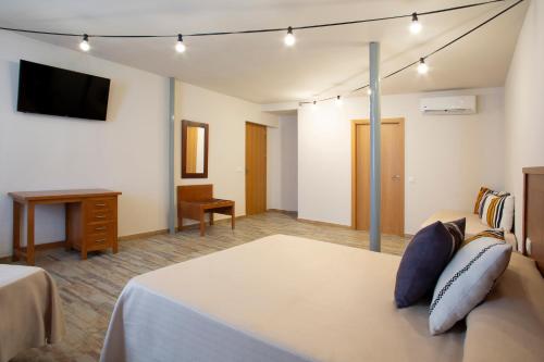 a hotel room with a bed and a television at tent Torremolinos in Torremolinos