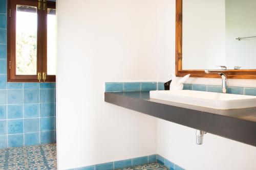a bathroom with a sink and a mirror at Khla Lodge in Kampot