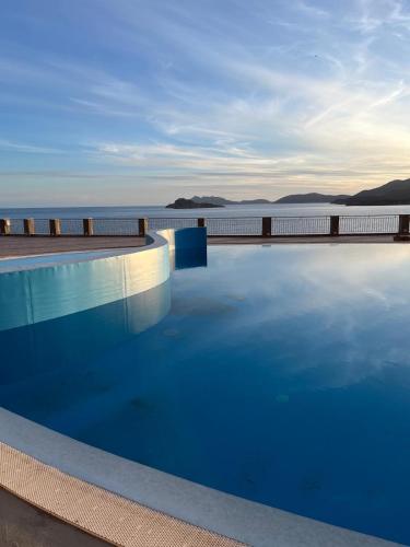 a swimming pool with a view of the water at Ste.Mar Apartments in Teulada