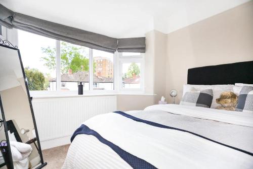 a bedroom with a bed and two windows at Pass the Keys Stunning home near Didsbury Village - Sleeps 6 in Manchester