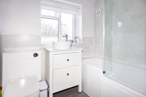 a bathroom with a sink and a toilet and a shower at Pass the Keys Stunning home near Didsbury Village - Sleeps 6 in Manchester