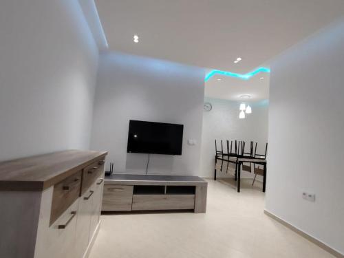 a living room with a flat screen tv and a couch at Appartement Sofia in Martil