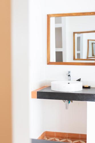 a bathroom with a sink and a mirror at Khla Lodge in Kampot