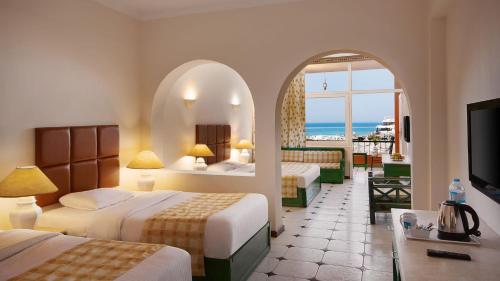 a hotel room with two beds and a view of the ocean at Giftun Azur Resort in Hurghada