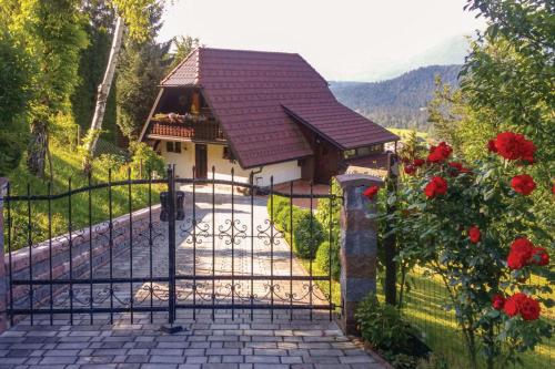a gate to a house with red roses at Bonidesa House With Whirlpool in Ljubno