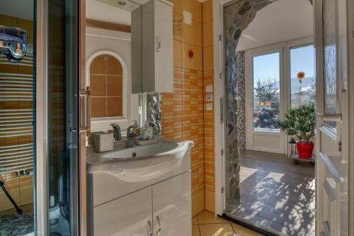 a bathroom with a sink and a mirror at Bonidesa House With Whirlpool - Happy Rentals in Ljubno
