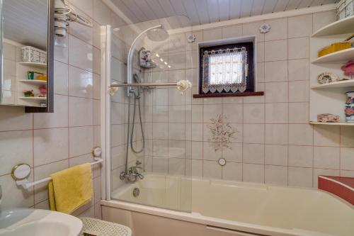 a bathroom with a shower and a tub and a sink at Bonidesa House With Whirlpool - Happy Rentals in Ljubno