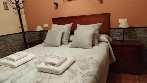 a bedroom with a bed with two towels on it at Casa Rural El Abuelo Anselmo in Segovia