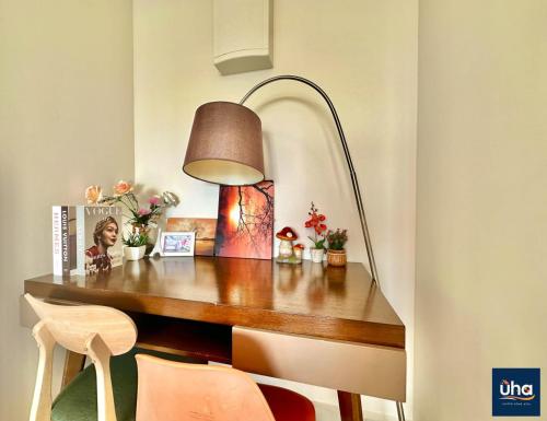 a desk with a lamp and a table with chairs at 1 Tebrau Residences By RR JBcity in Johor Bahru