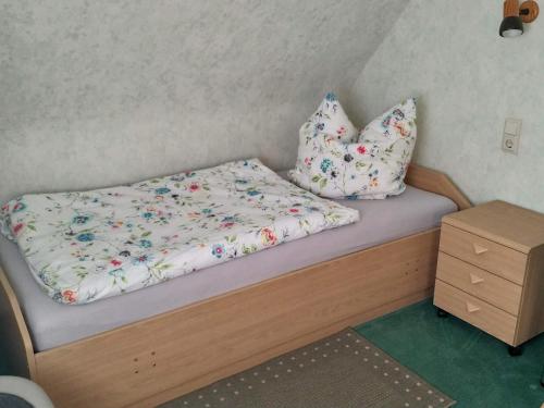 a bed with two pillows on it in a room at Ferienwohnung Morretalblick in Buchen
