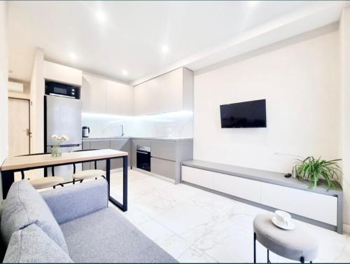 a living room with a couch and a table at Most City Area Lux Studio in Dnipro