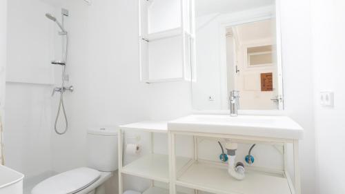 a white bathroom with a sink and a toilet at Anna I in Llafranc