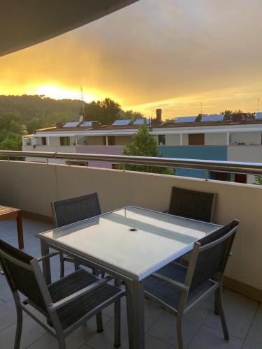 a table and chairs on a balcony with a building at Casa del Porto in Pesaro