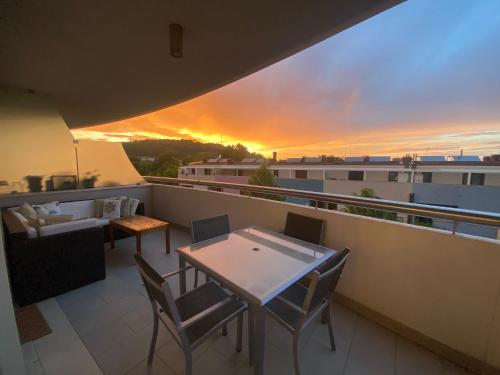 a balcony with a table and chairs and a sunset at Casa del Porto in Pesaro