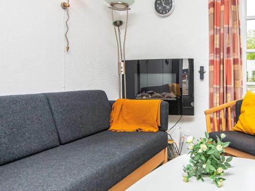 a living room with a couch and a table at 5 person holiday home in R m in Sønderby