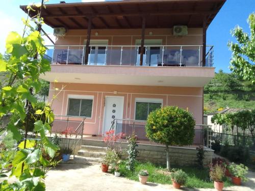 a house with a balcony in front of it at Bujtina Bego in Çorovodë