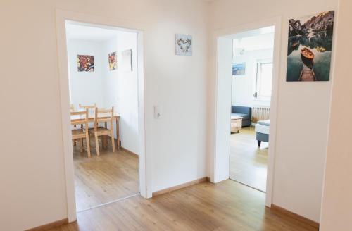 a room with two doors and a dining room at Familytime am Traunsee in Altmünster