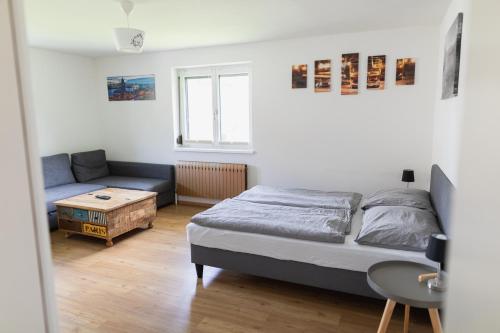 a bedroom with a bed and a couch at Familytime am Traunsee in Altmünster