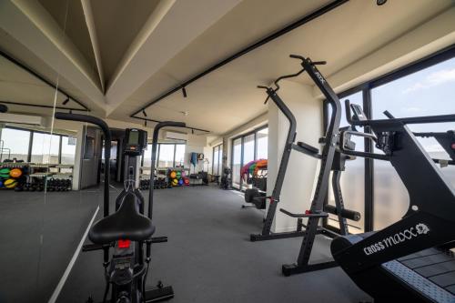a gym with several treadmills and bikes in it at Park Heights by the Warren Collection in Msida