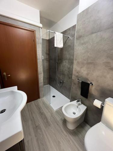 a bathroom with a shower and a toilet and a sink at Biri's House in Reggio Emilia