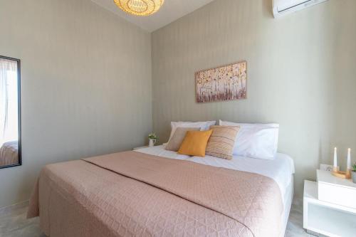 a bedroom with a bed with orange and white pillows at Grande Terra in Kiotari