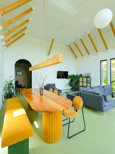 a living room with a wooden table and chairs at Pin Boutique Hotel in Dealu Frumos