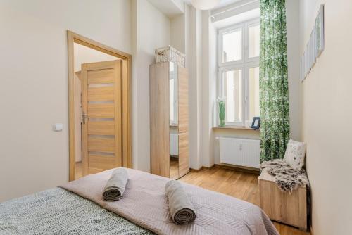 biała sypialnia z łóżkiem i oknem w obiekcie Apartament Fair Targi Dworzec POZNAŃ Gąsiorowskich w Poznaniu