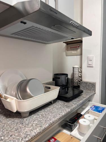 a kitchen counter with a sink and a stove at Amani Grand Citygate at the back of Gaisano Milan in Davao City