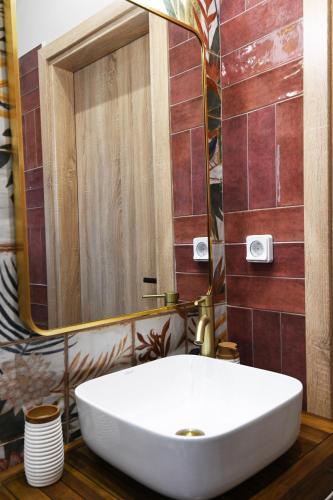 a bathroom with a white sink and a mirror at Vivis Hub in Argostoli