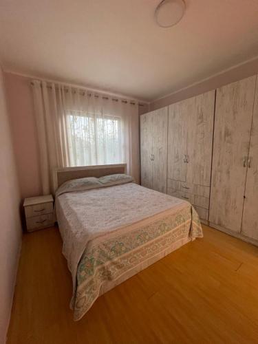 Schlafzimmer mit einem Bett und einem Fenster in der Unterkunft Private House Shkoder in Shkodra
