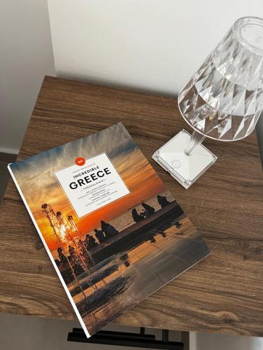 a magazine sitting on a table next to a lamp at Naiades Villas Lilea in Ladharió
