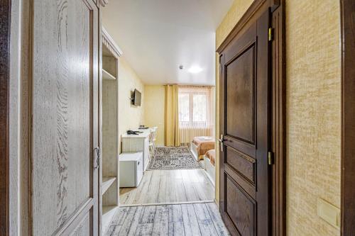 a room with a hallway with a door and a bathroom at Diamond Resort White in Bukovel