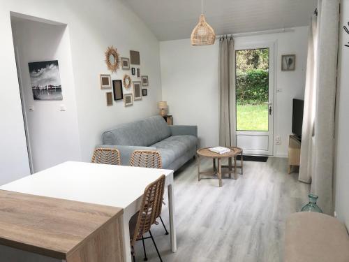 a living room with a couch and a table at La Palaine, maison à 150m de la mer in La Plaine-sur-Mer