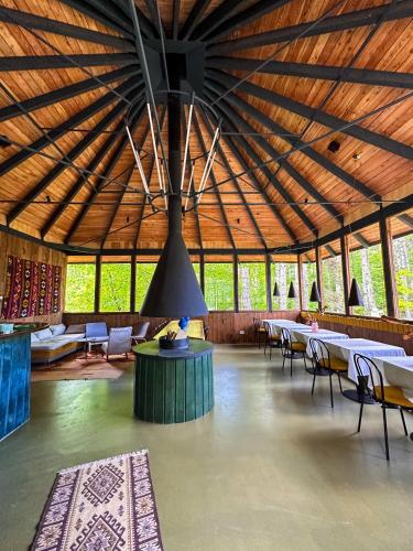 a large room with tables and chairs and a large ceiling at Pin Boutique Hotel in Dealu Frumos