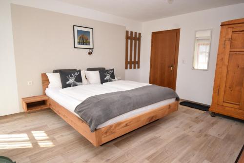 a bedroom with a large bed in a room at Zugspitzblick in Bichlbach