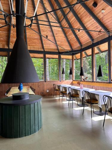 a large room with tables and chairs in a building at Pin Boutique Hotel in Dealu Frumos