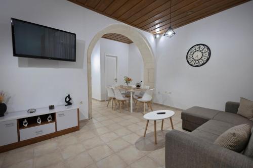 a living room with a couch and a table at Dianna Residence in Rethymno Town