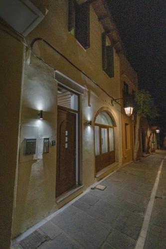 a building with a door on a street at night at Dianna Residence in Rethymno Town